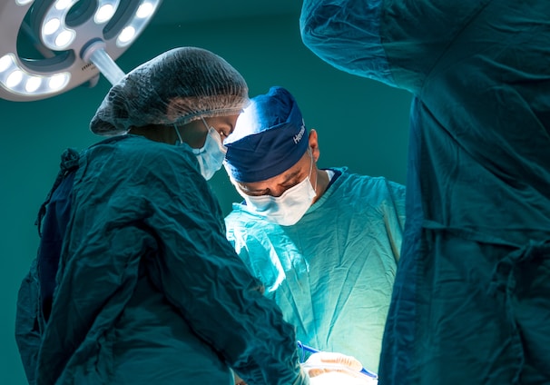 a group of doctors performing surgery on a patient